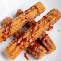 Churros Con Cajeta · Mexican donuts served with caramel dipping sauce