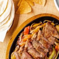 Fajitas Steak · Build your own taco with grilled onions, peppers, guacamole, salsa roja, pico de gallo, sesa...