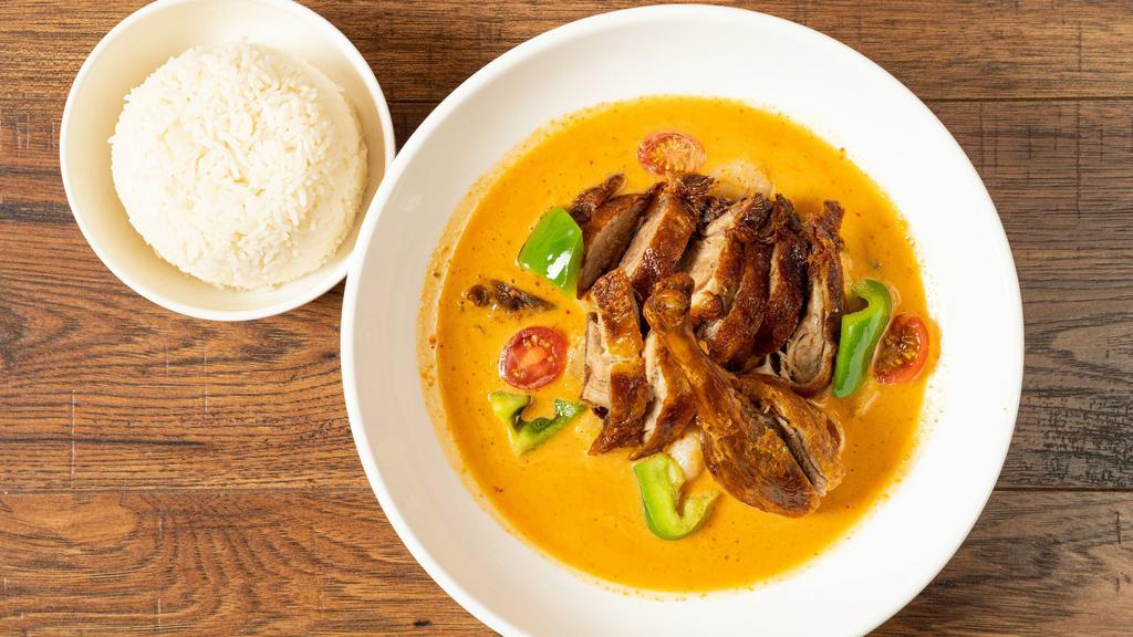 Duck Pineapple Curry · Spicy. Marinated crispy duck in pineapple curry with lychee, bell pepper, cherry tomato, and basil leaves. Served with jasmine rice.