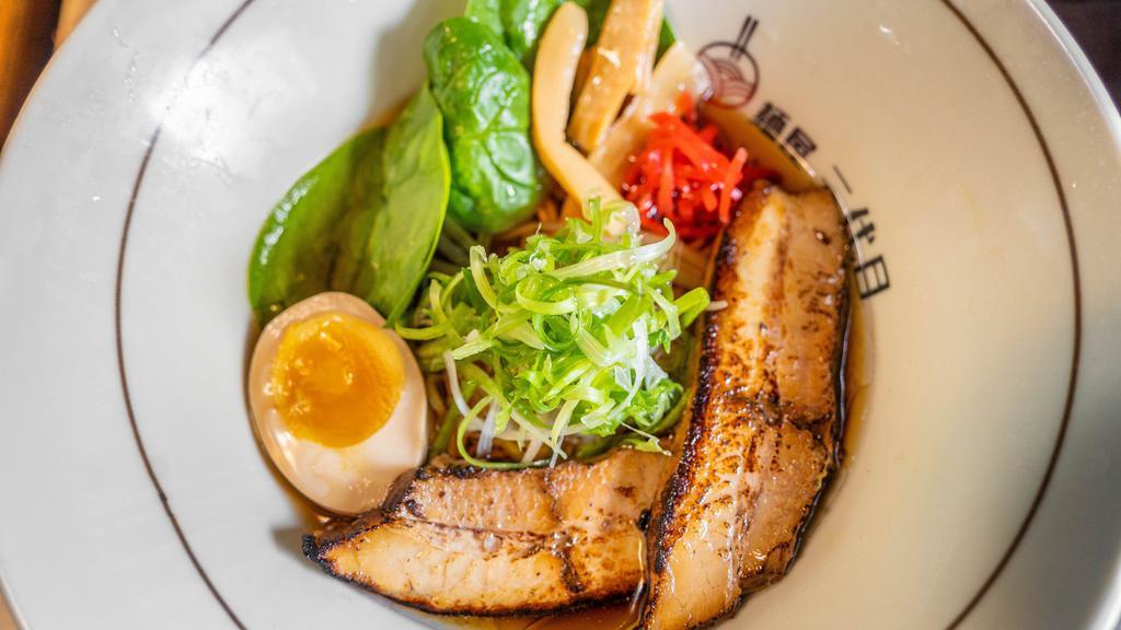 Shoyu Ramen · Rich soy sauce based soup and noodles. Topped with bean sprouts, scallions, spinach, marinated egg, and grilled pork belly.