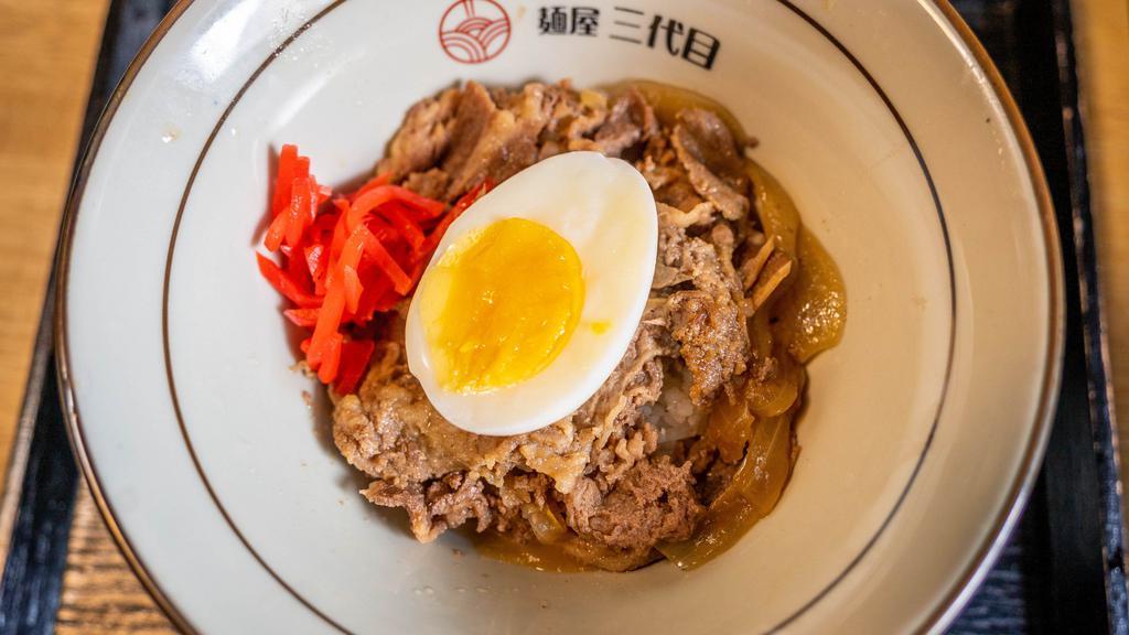 Gyudon · Stewed thin slices of beef on rice. Topped with pickled ginger and marinated egg.