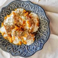 Mantu · Afghan style dumplings filled with ground beef, onions, and savory seasonings. Garnished wit...
