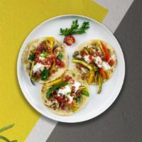 Best Of Mexico Vegan Taco · Hard taco shell, two soft taco shell with chili beans, crowned with vegan Muenster cheese ov...