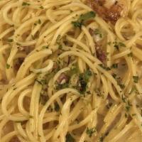 Spaghetti Carbonara · Cream sauce with sautéed bacon, prosciutto and onions.