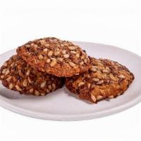 Kitchen Sink Cookie · Spiced oat cookie with flaxseed, grated carrot, raisins, and chocolate chips.