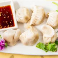 Steamed Dumplings · Six pcs. Hand wrapped, house pork dumplings served with ginger soy dipping sauce.