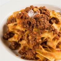 Pappardelle Alla Bolognese · flat ribbon pasta finished in a veal and beef ragu with a touch of cream.