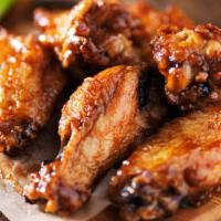 Bbq Bone-In Chicken Wings (12) · Fresh wings crisp to perfection tossed in BBQ sauce.