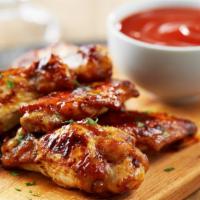 Honey Bbq Wings (7 Pieces) · Flavorful classic and deep fried bone in wings tossed in honey BBQ sauce.