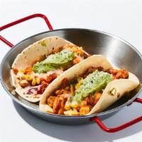 Peli Chicken Taco · 2 pieces of soft tortillas topped with marinated chicken, corn, cilantro, assorted vegetable...