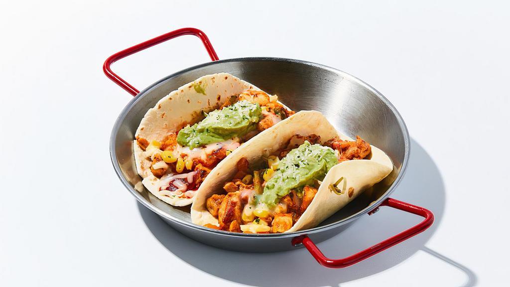 Peli Chicken Taco · 2 pieces of soft tortillas topped with marinated chicken, corn, cilantro, assorted vegetables, guacamole and mozzarella cheese. Choice of Mild / Spicy.