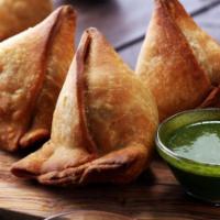 Samosa (2 Pieces) · Fried pastry with a savory filling, such as spiced potatoes, onions, peas, cheese, and lentils