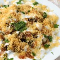 Papri Chaat · Combination of crispies, boiled potatoes, chick peas topped with yogurt, mint sauce and tama...