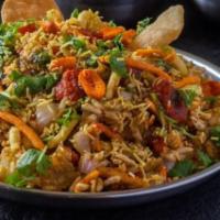 Bhel Puri · Puffed rice crisps garnished with vegetables, mint sauce and tamarind sauce