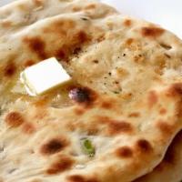 Onion Kulcha · Soft flour bread mixed with minced garlic and baked in a tandoori oven and then coated with ...