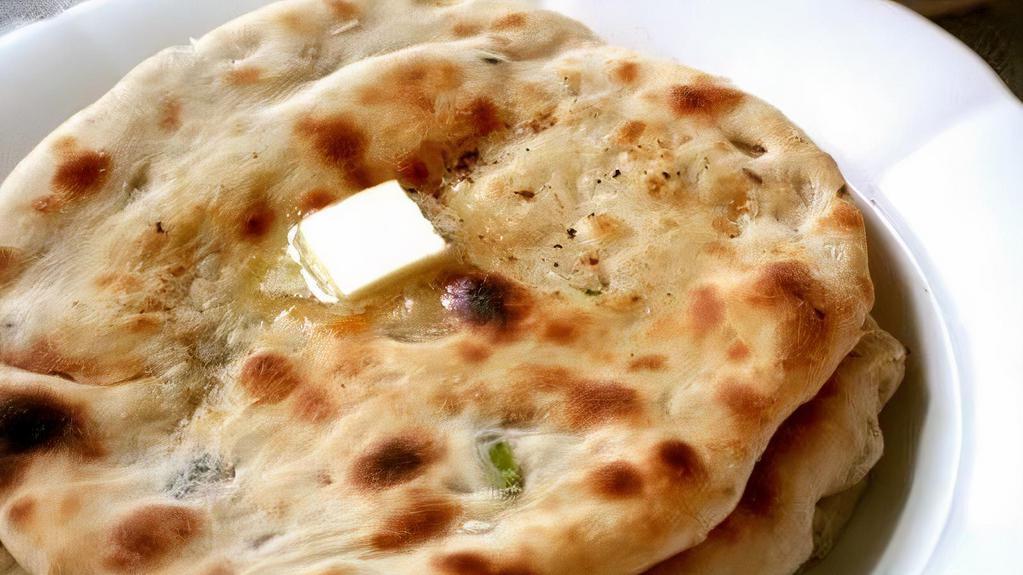 Onion Kulcha · Soft flour bread mixed with minced garlic and baked in a tandoori oven and then coated with melted butter