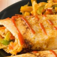 Spring Dosa · Crepe (made with rice and lentil dough) stuffed with potatoes, onions and mixed veggies