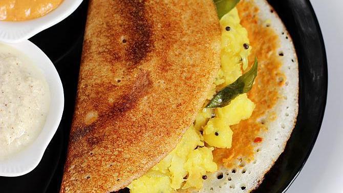 Mysore Masala Dosa · Crepe (made with rice and lentil dough) stuffed with potatoes, onions and nuts with a layer of hot chutney