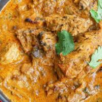 Chicken Korma · Chicken pieces cooked in a sauce of onions, tomatoes, coconut, poppy seeds, and Indian spices