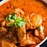 Chicken Curry · Chicken cooked with onions, tomatoes, ginger, garlic and a blend of spices