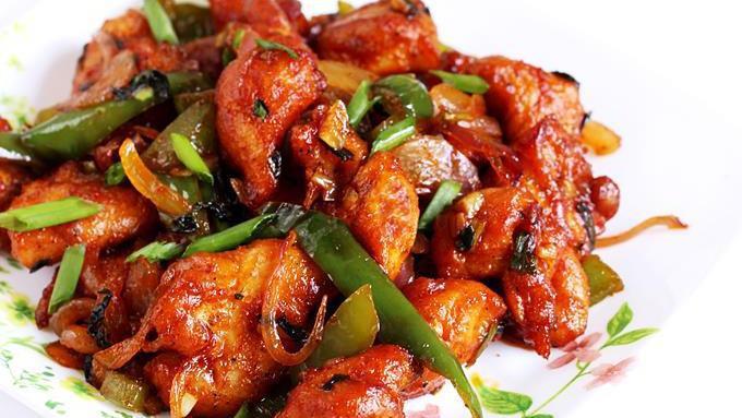 Chili Chicken · Fried boneless chicken pieces sauted with onions, bell peppers, ginger, garlic, herbs in soy sauce