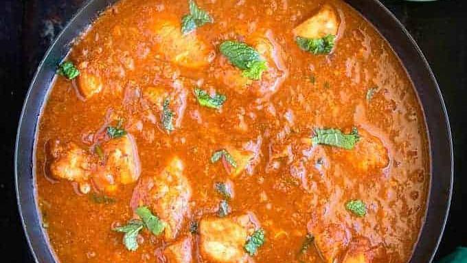 Chicken Vindaloo · Chicken pieces cooked in a sauce of onions, tomatoes, coconut, and Indian spices