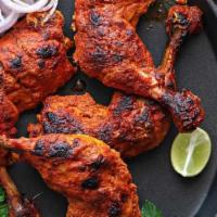 Tandoori Chicken · Roasted chicken marinated in yogurt and spices in a cylindrical clay oven