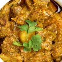 Goat Curry · Goat pieces cooked with onions, tomatoes, peppers and a blend of Indian spices