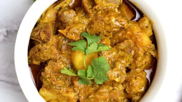 Goat Curry · Goat pieces cooked with onions, tomatoes, peppers and a blend of Indian spices
