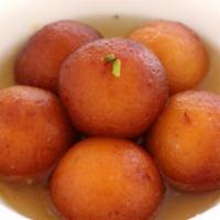 Gulab Jamun · Fried balls (made with milk and flour) soaked in sweet flavored syrup, topped with nuts