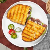 Philly Cheesesteak Panini · Layers of beef strips, peppers, onions, and your choice of cheese served on a flat panini br...