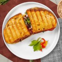 Triple Decker Club Panini · Ham, bacon, and turkey served on a flat panini bread.