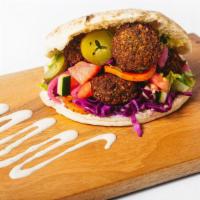 Falafel Sandwich · Original recipe or spicy jalapeno falafels in a fluffy pita with Hummus, lettuce and a choic...