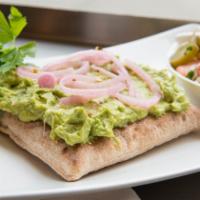 Mashed Avocado Pita Toast · Mashed Avocado on a toasted square pita topped with pickled onions and red pepper flakes.  C...