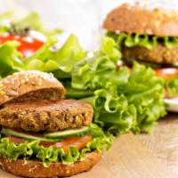 Vegetarian Burger · Delicious Veggie Burger freshly prepared and topped with lettuce, tomato, ketchup, and mayo.