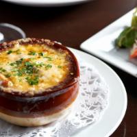 Onion Soup · Traditional French onion soup served with croutons, topped with Swiss cheese and Gratinée in...