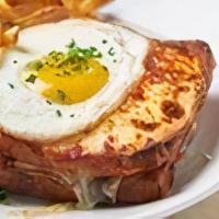 Croque Madame · Traditional baked sourdough ham and Swiss cheese sandwiches served with French Fries.