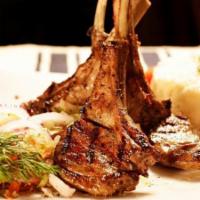 Lamb Chops · Char-grilled four pieces of baby lamb chops, served with rice and salad.