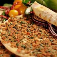 Lahmacun · Two pieces. A Turkish style pizza. Flat bread dough topped with lamb and chopped garden vege...