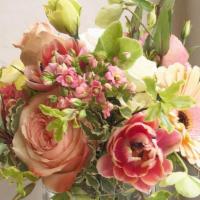 Lora · A lovely peach and pink toned seasonal floral arrangement in a clear glass vase.

*Photo ser...