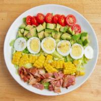 Cobb Salad · Avocado, Bacon, Corn, Hard-Boiled Eggs and Cherry Tomatoes over greens.