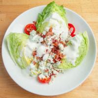 Wedge Salad · Iceberg Lettuce with Bacon, Blue Cheese, Cherry Tomatoes and Blue Cheese Dressing.