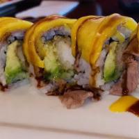 Fashion Dragon Roll · Shrimp tempura, avocado, and cucumber inside; topped with a layer of steak and mango