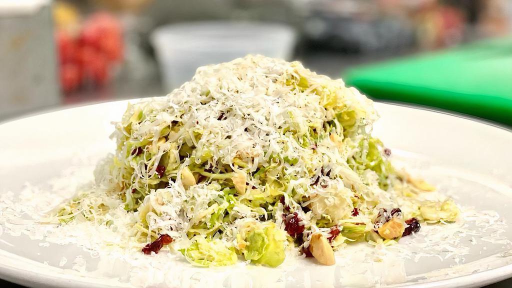 Brussel Sprout Salad · Nuts, gluten free, vegetarian. Brussels sprout, aged parmigiano, dried cranberries, toasted marcona almonds, lemon-mustard vinaigrette.
