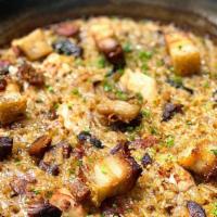 Paella De Carne · Gluten free. Classic Spanish bomba rice, sofrito, saffron, mushrooms, pork belly, chicken, c...