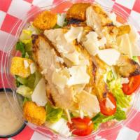 Chicken Caesar Salad · Grilled chicken breast sliced over fresh romaine lettuce, Parmesan cheese, croutons, grape t...