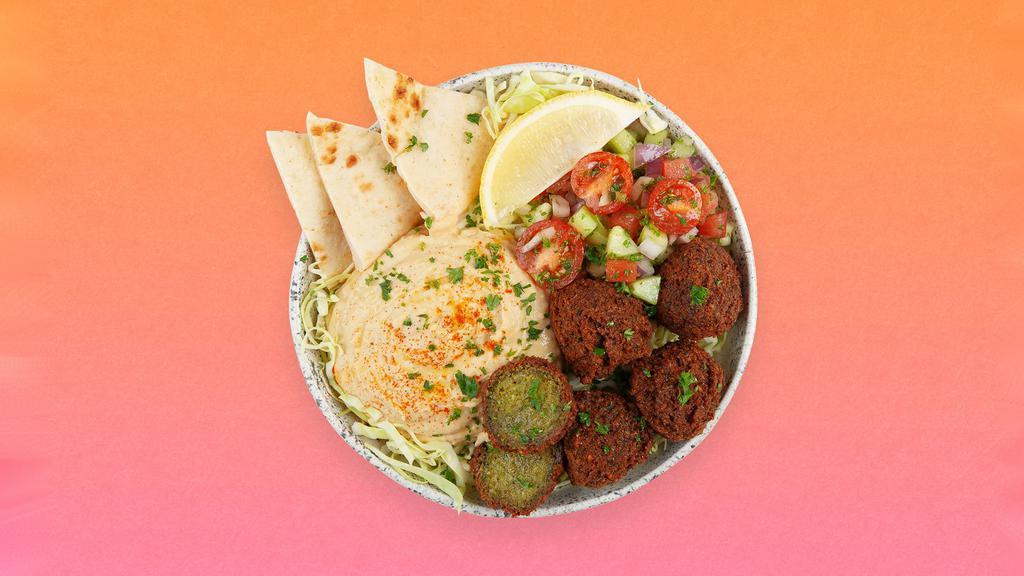 Falafel Hummus Bowl · Crispy falafel over hummus, diced cucumber and tomato salad, shredded green cabbage and a drizzle of tahini sauce.