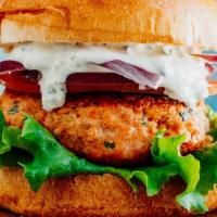 Salmon Burger  · fresh wild salmon patty . mixed green .pepper jack cheese and chipotle dressing