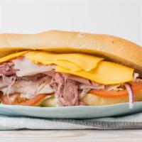 American Hero Sandwich · Roast beef, ovengold turkey, ham, American cheese, lettuce, tomato, and mayonnaise on a hero...
