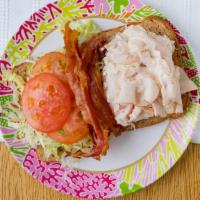 Turkey Club Sandwich · Ovengold turkey, bacon, lettuce, tomato, and mayonnaise on a toasted whole wheat bread. Made...